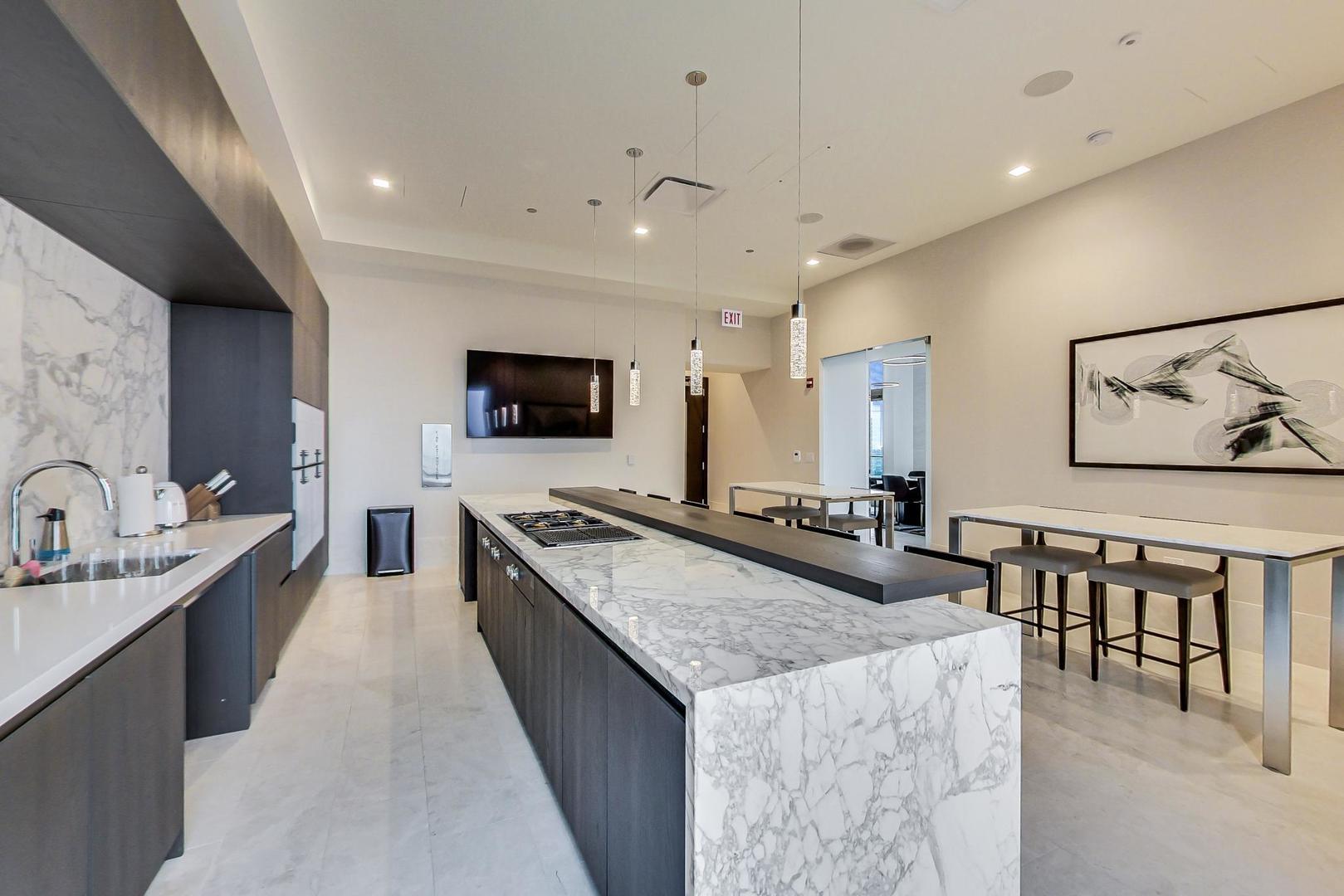 363 East Wacker Drive, Unit 2708 Chicago, IL 60601 - Photo 28 of 48 a large living room with stainless steel appliances granite countertop a couch a sink dishwasher a dining table and chairs