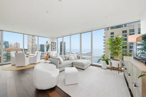 a living room with furniture and a floor to ceiling window