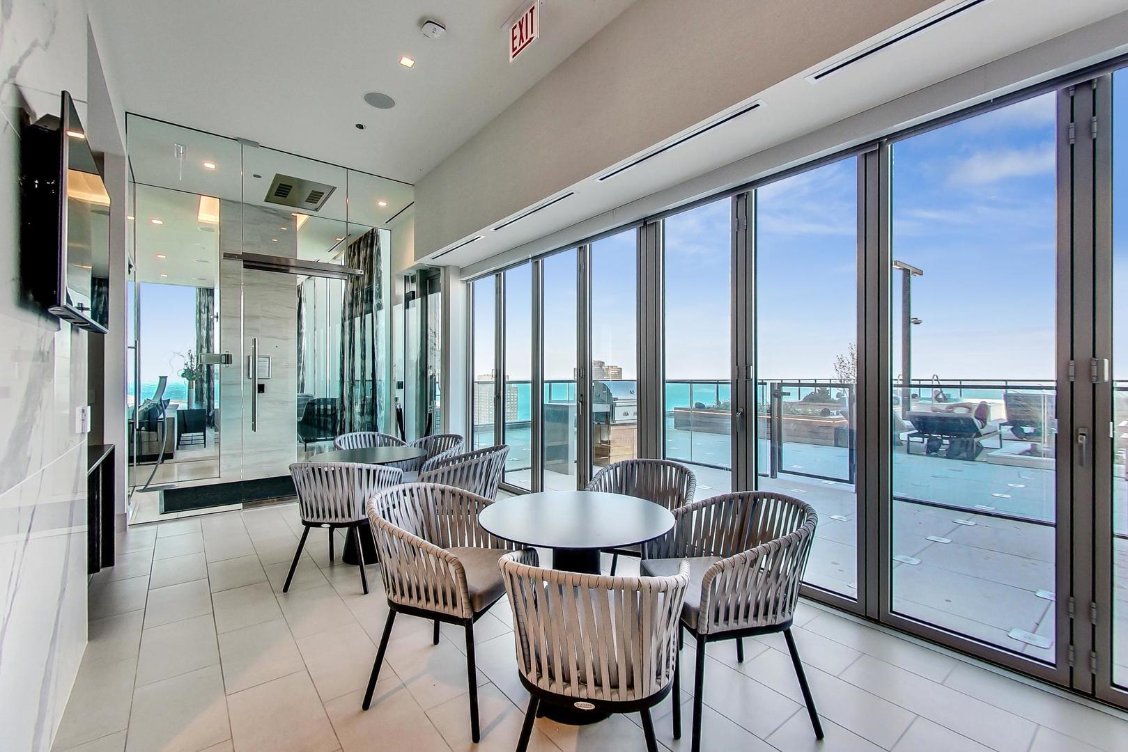 363 East Wacker Drive, Unit 2708 Chicago, IL 60601 - Photo 41 of 48 a dining room with furniture and a floor to ceiling window