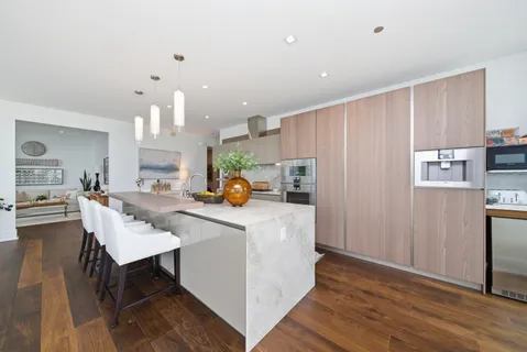 a bathroom with a granite countertop bathtub a sink and a large mirror