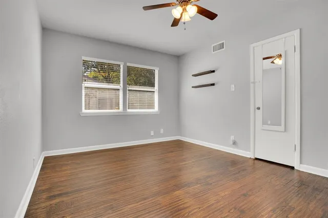 wooden floor in an empty room with a window
