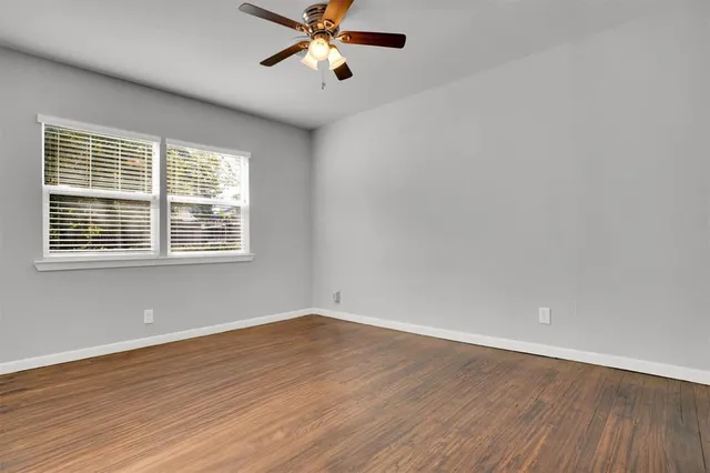 a view of a room with wooden floor and windows