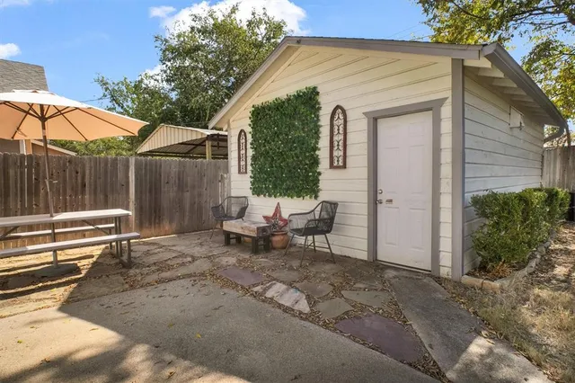 a view of a backyard with chairs and a patio