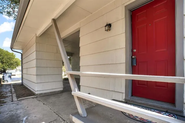 a front view of a house with a yard and large trees