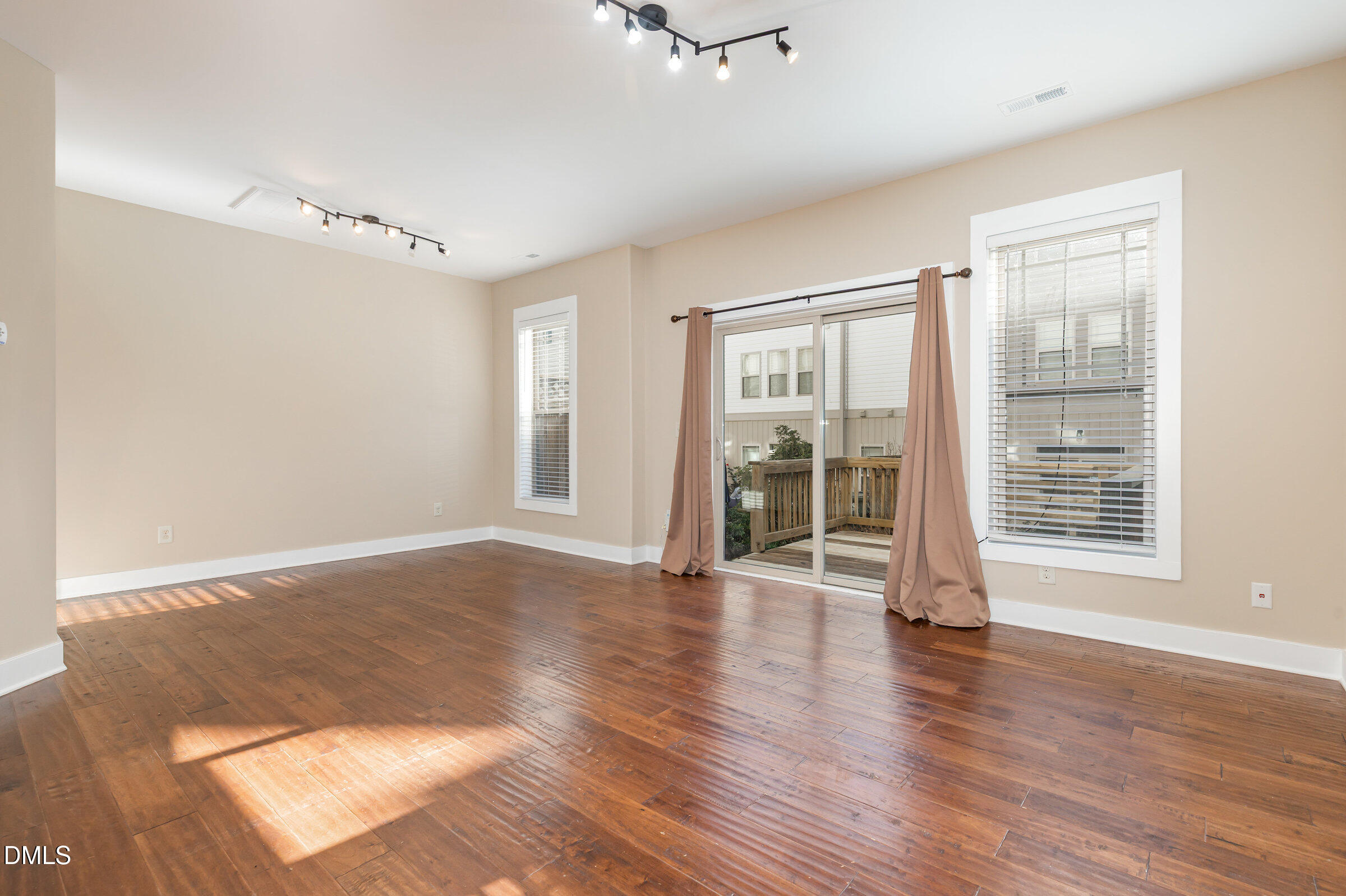3827 Glenhaven Road Raleigh, NC 27606 - Photo 4 of 32 wooden floor in an empty room with a window