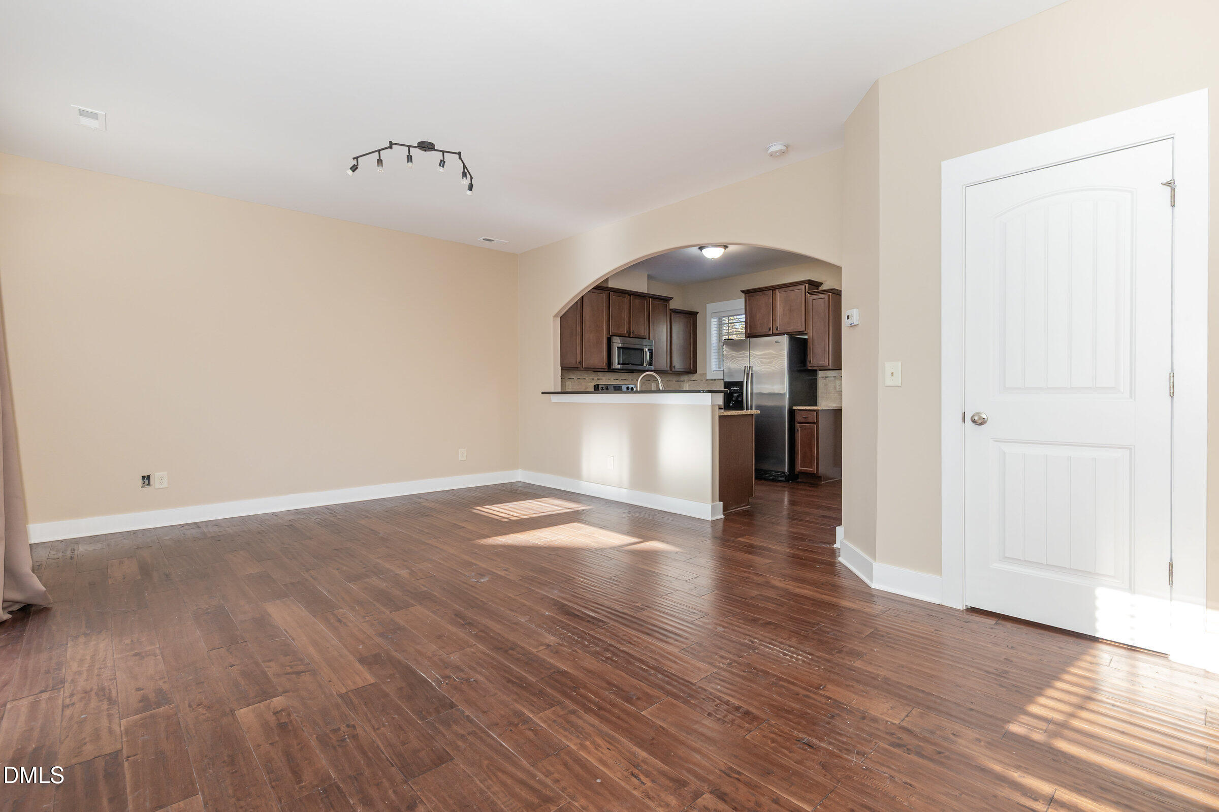3827 Glenhaven Road Raleigh, NC 27606 - Photo 5 of 32 a view of a kitchen with a wooden floor and a refrigerator