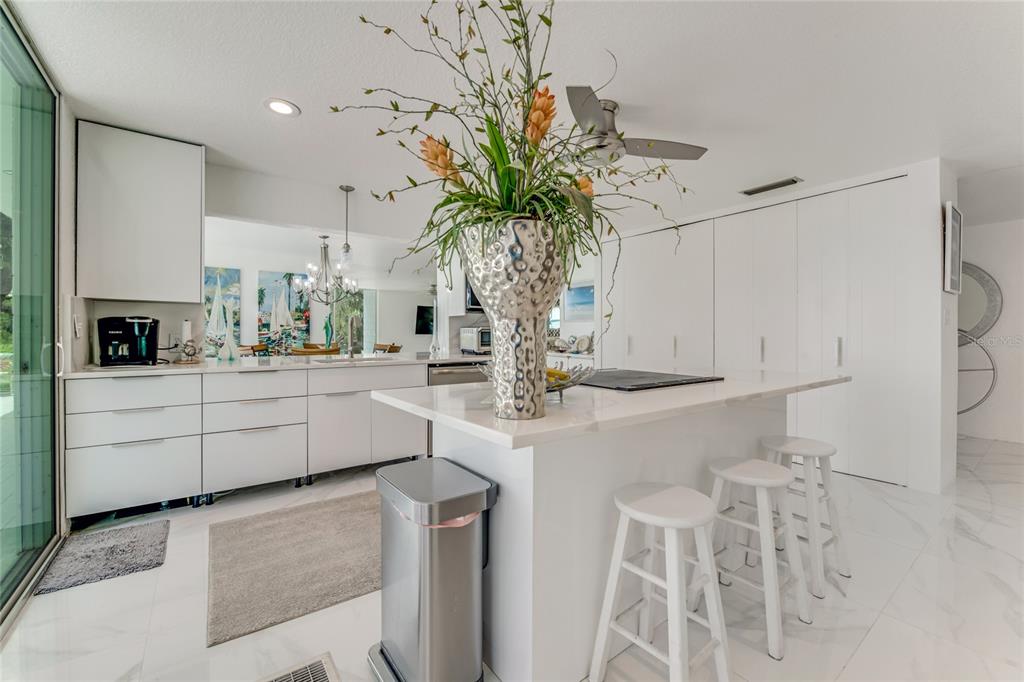 2600 Fort Lane Road Geneva, FL 32732 - Photo 11 of 28 a kitchen with white cabinets and chandelier