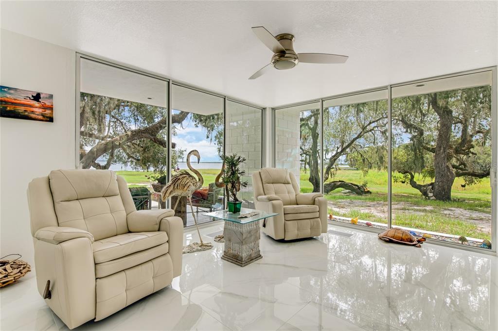 2600 Fort Lane Road Geneva, FL 32732 - Photo 6 of 28 a living room with furniture and a floor to ceiling window