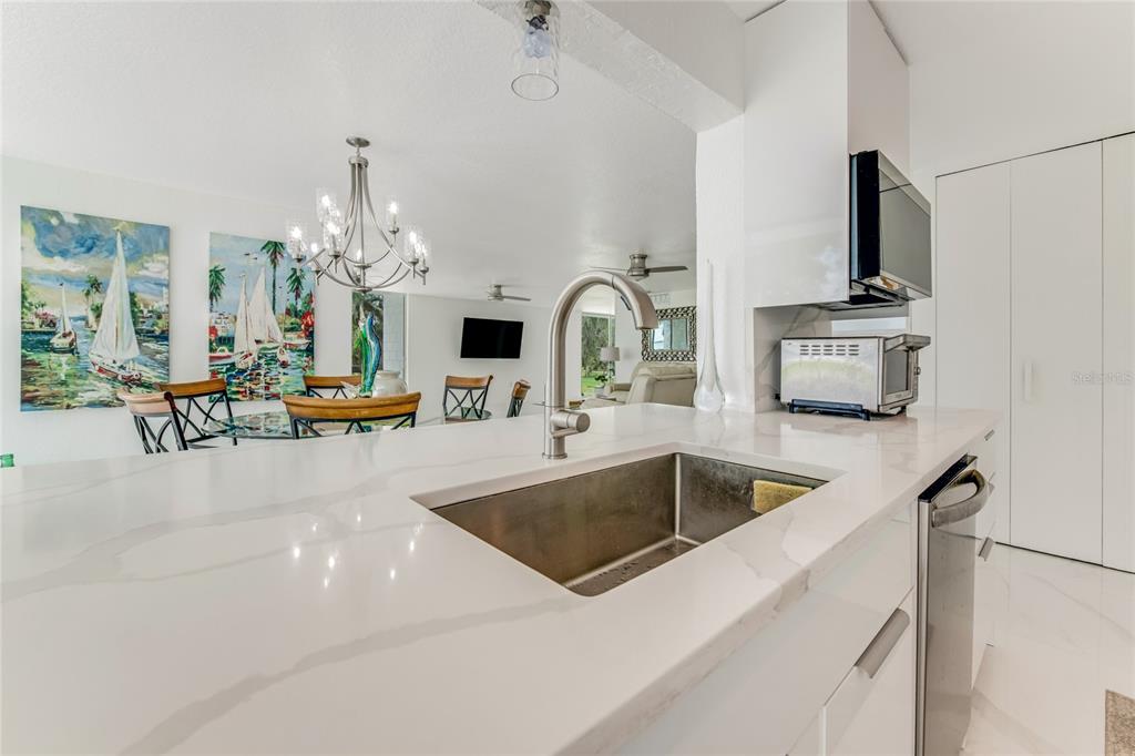 2600 Fort Lane Road Geneva, FL 32732 - Photo 10 of 28 a kitchen with kitchen island a sink and a stove top oven