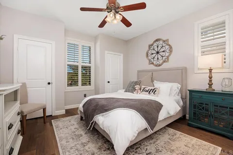 a living room with furniture a window and a clock