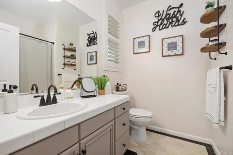 a living room with furniture a ceiling fan and a window