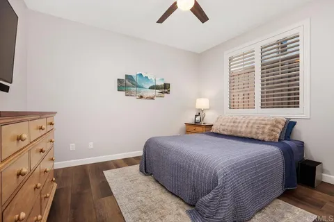 a living room with furniture and a ceiling fan