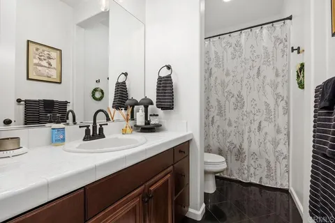 a view of a patio with couches table and chairs under an umbrella