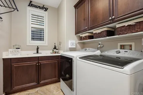 a view of a patio with table and chairs under an umbrella