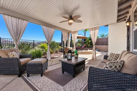 a front view of a house with a garden and plants