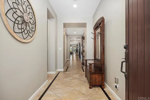a kitchen with a dining table chairs and refrigerator