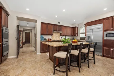 a kitchen with stainless steel appliances granite countertop a stove and a sink