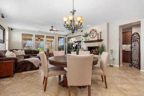 a living room with furniture and view of kitchen