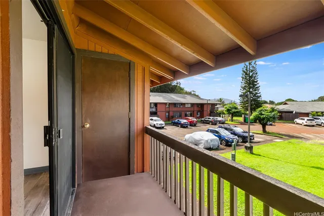a view of a porch with furniture and garden
