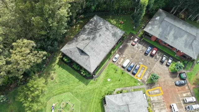 an aerial view of a house with garden space and street view