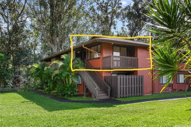 a small barn with a small yard and large trees