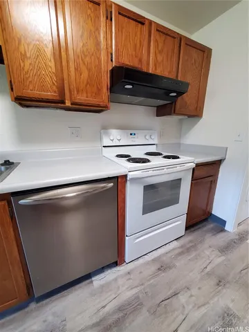 a stove top oven sitting inside of a kitchen