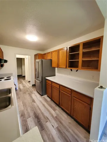 a kitchen with stainless steel appliances a refrigerator and wooden cabinets