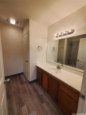 a spacious bathroom with a double vanity sink and mirror
