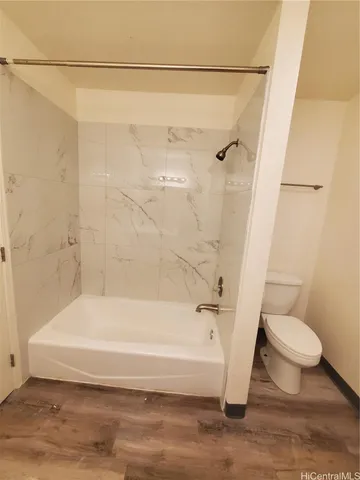 a bathroom with a toilet and a bathtub