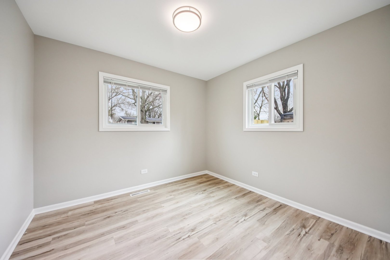 65 Della Street Crystal Lake, IL 60014 - Photo 17 of 28 a view of an empty room with wooden floor and a window