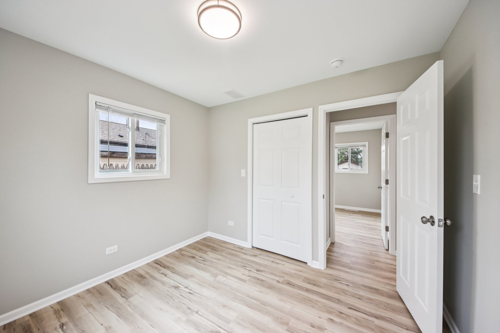 65 Della Street Crystal Lake, IL 60014 - Photo 18 of 28 an empty room with wooden floor and windows