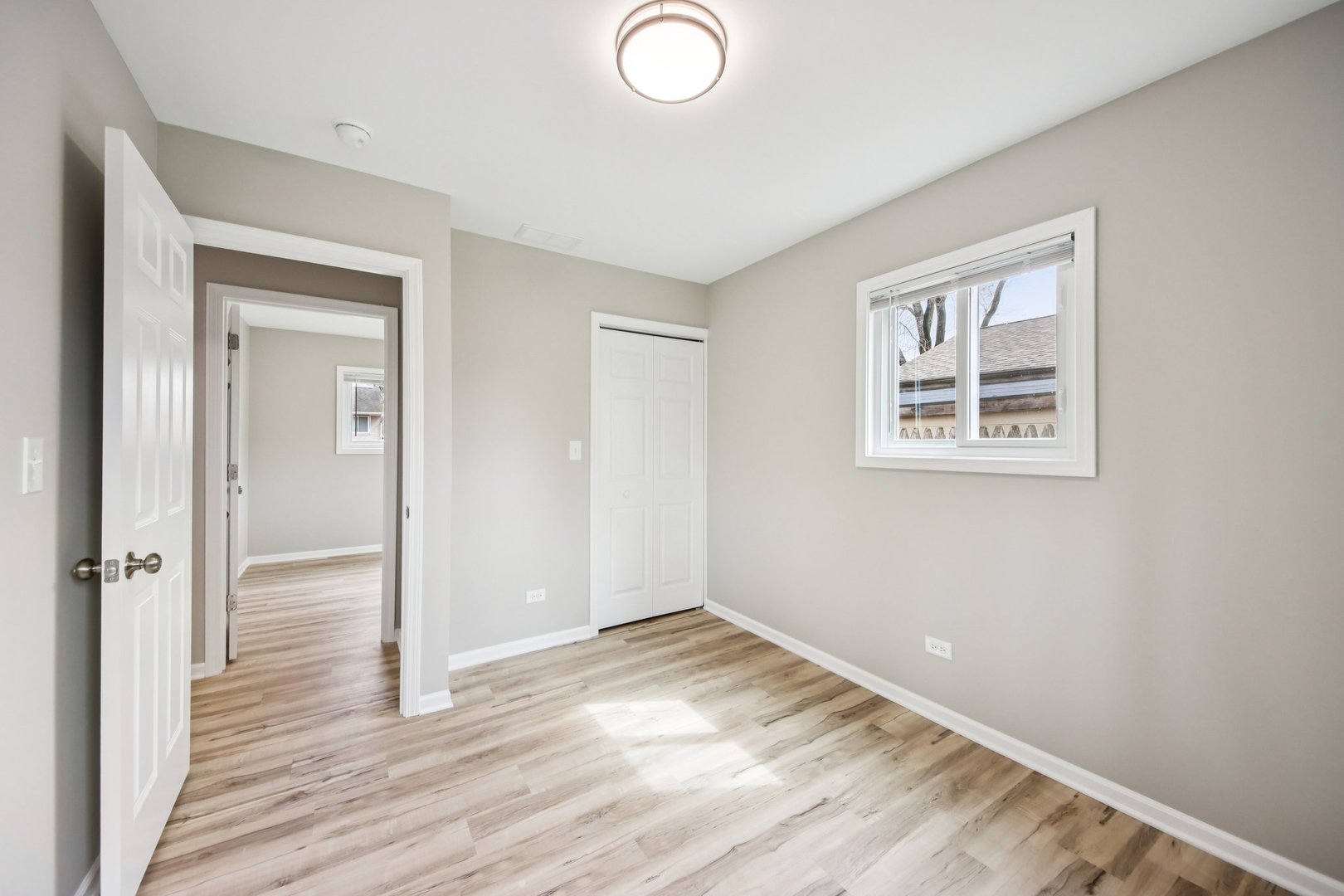 65 Della Street Crystal Lake, IL 60014 - Photo 21 of 28 an empty room with wooden floor and windows