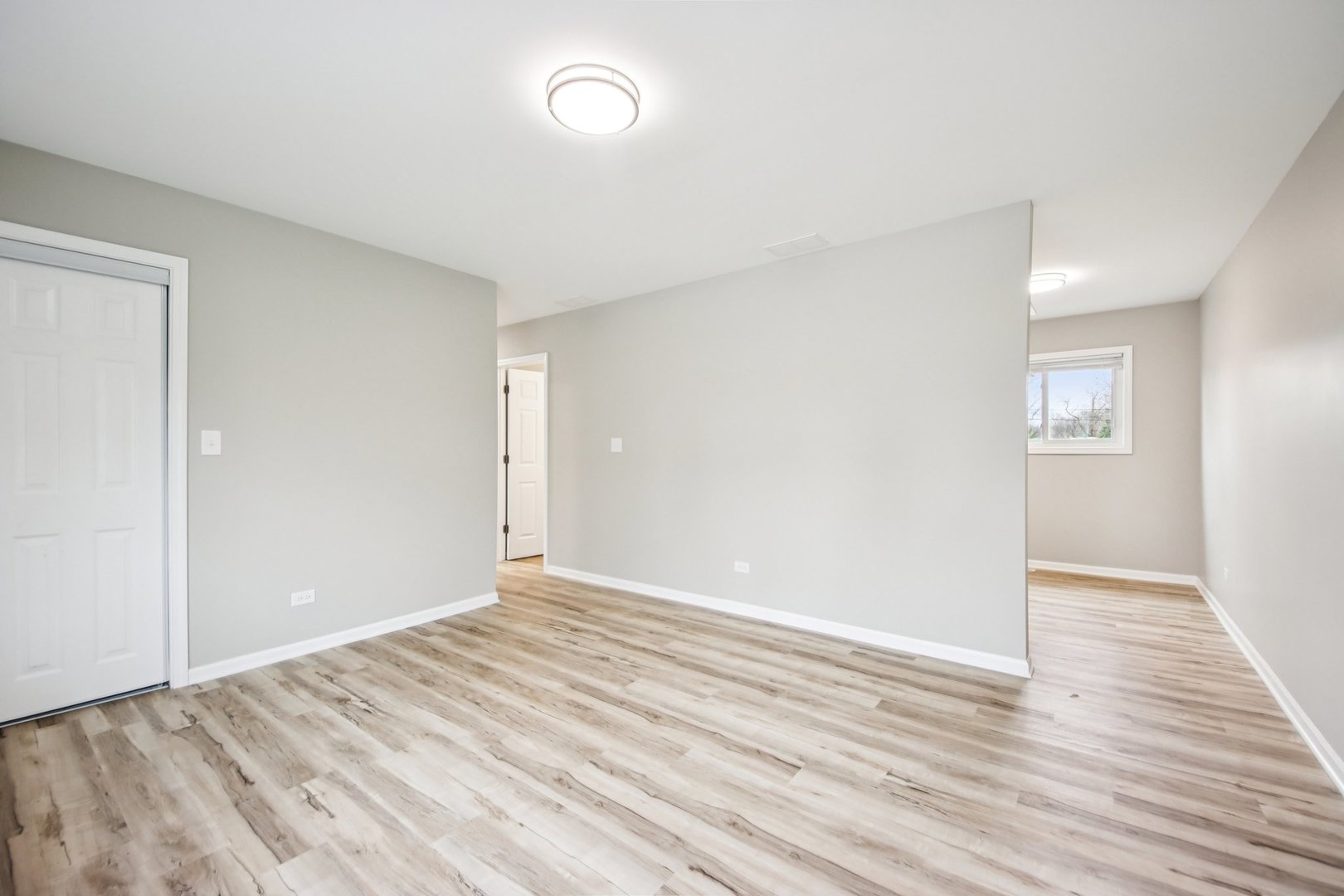 65 Della Street Crystal Lake, IL 60014 - Photo 5 of 28 an empty room with wooden floor and windows