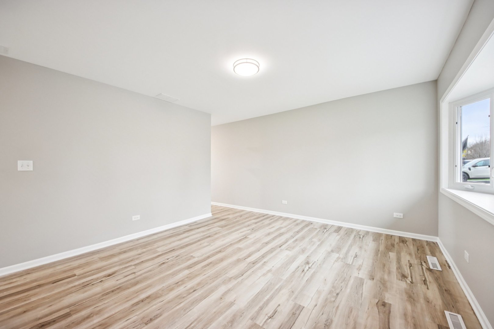 65 Della Street Crystal Lake, IL 60014 - Photo 7 of 28 a view of an empty room with wooden floor and a window