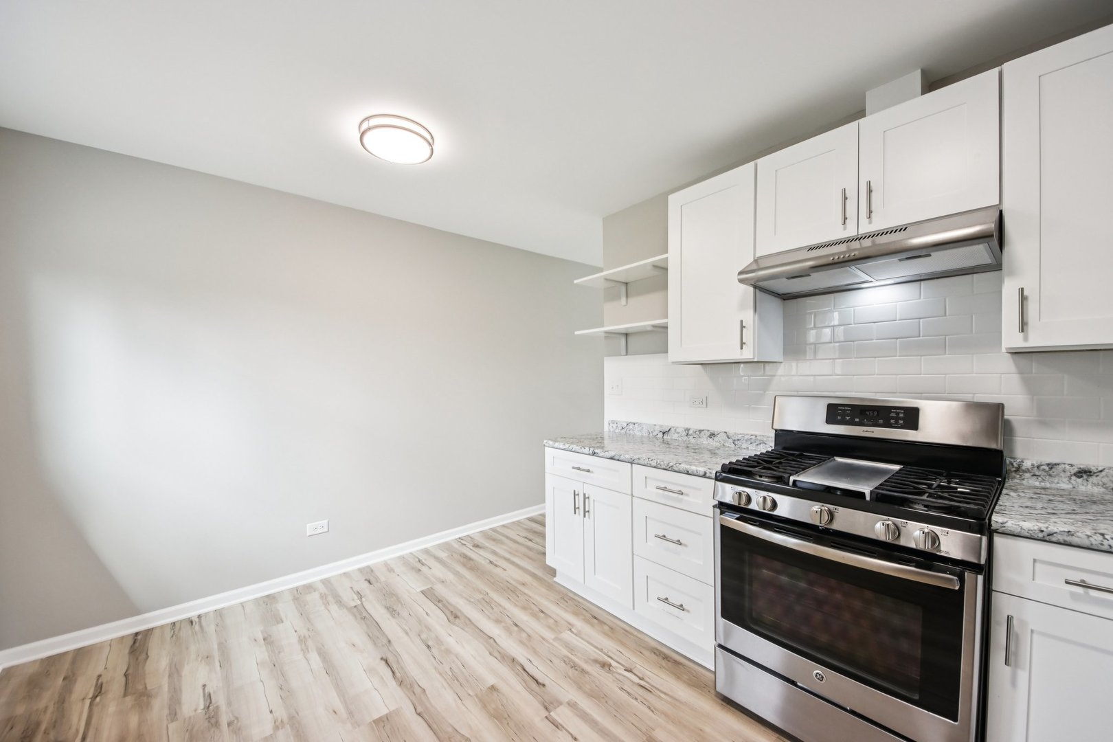 65 Della Street Crystal Lake, IL 60014 - Photo 9 of 28 a kitchen with granite countertop a stove and a sink