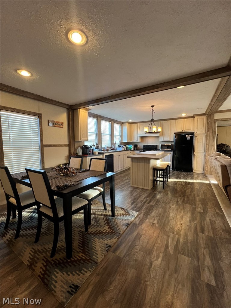 53720 Highway 681 Reedsville, OH 45772 - Photo 8 of 25 Open-concept living area featuring wood-finish flooring throughout, recessed lighting, and a kitchen island with seating