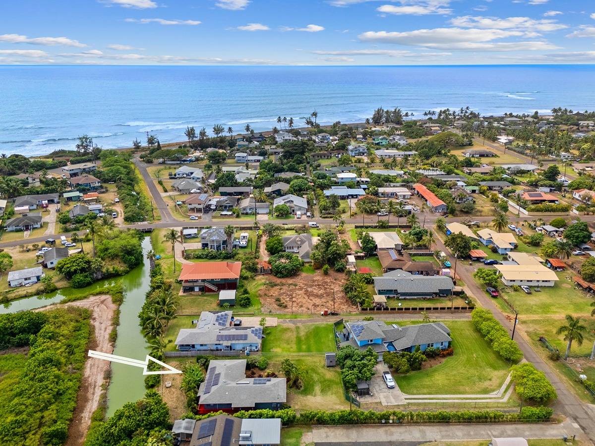 Two blocks to the beach. Niihau on the horizon. Hundreds of green acres across the canal. Here you can sit back, relax, strum your ukelele, and count your blessings.
