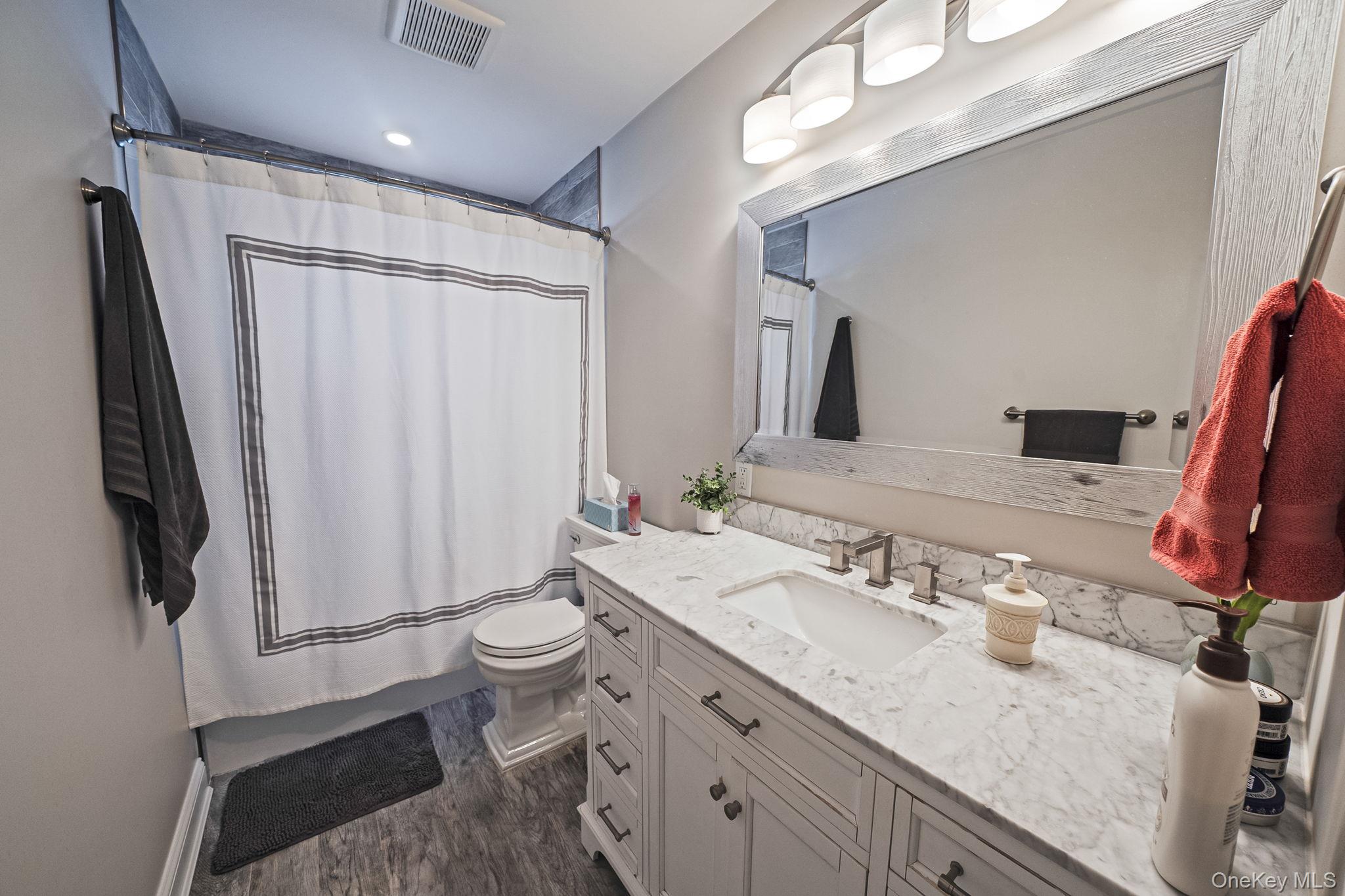 110 Stephen Road Bayport, NY 11705 - Photo 26 of 39 a bathroom with a granite countertop sink toilet and shower