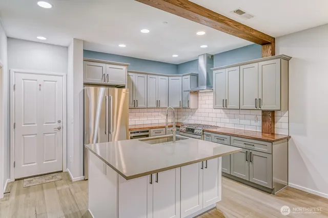 a kitchen with a sink a stove a refrigerator and cabinets