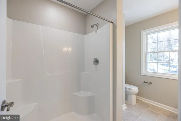 a bathroom with a toilet a sink and shower