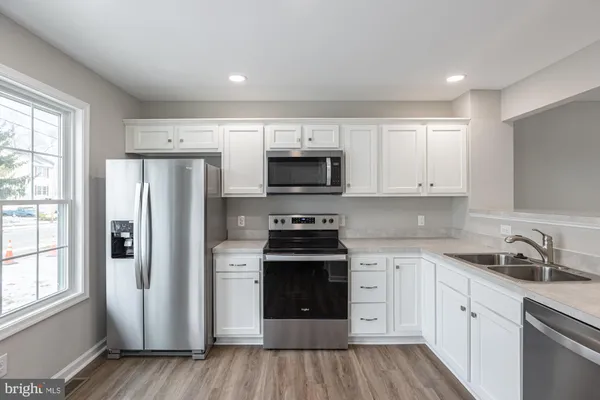 a kitchen with a stove and a refrigerator