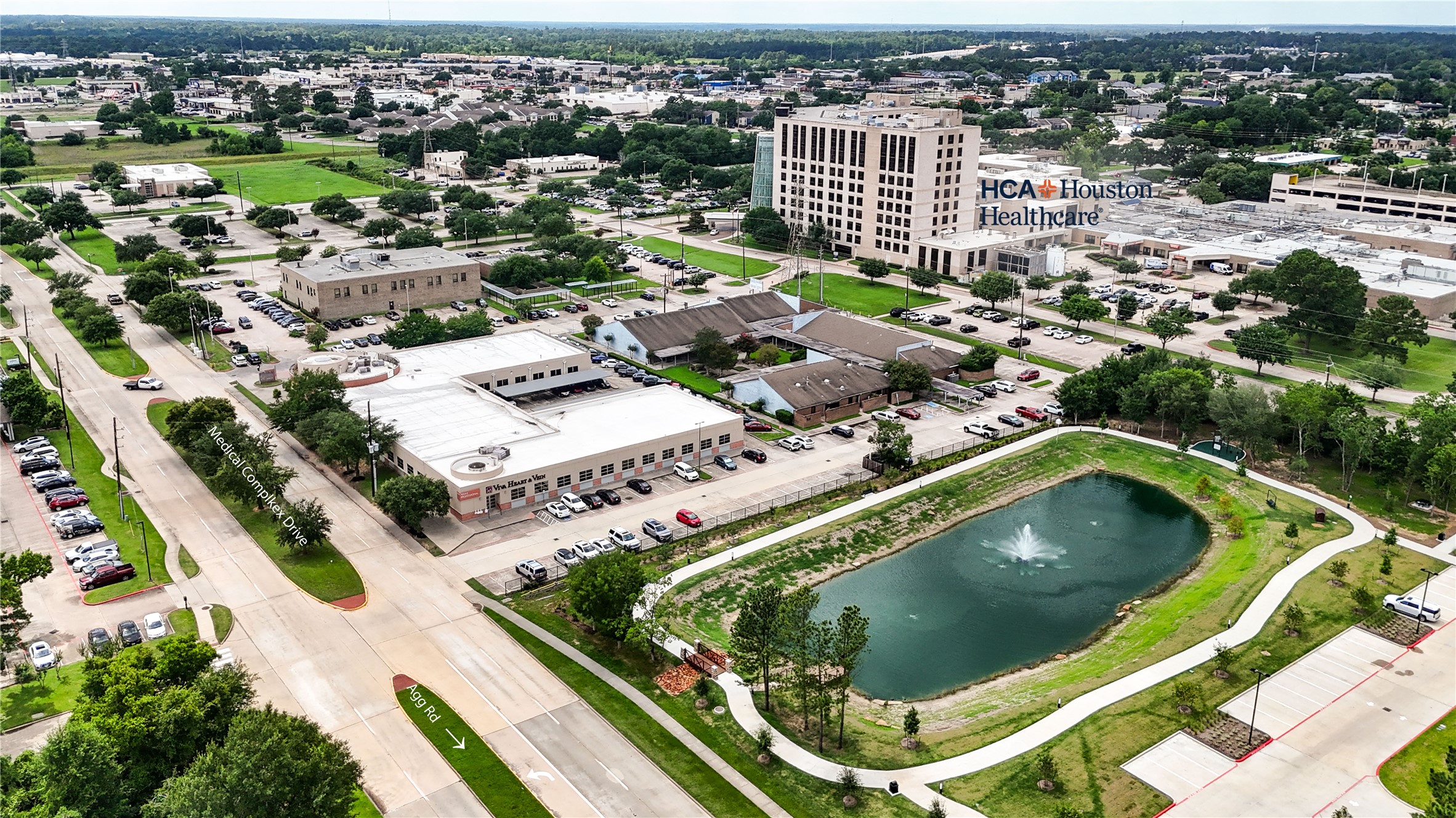 922 Agg Road Tomball, TX 77375 - Photo 19 of 23 an aerial view of a house with a garden and lake view