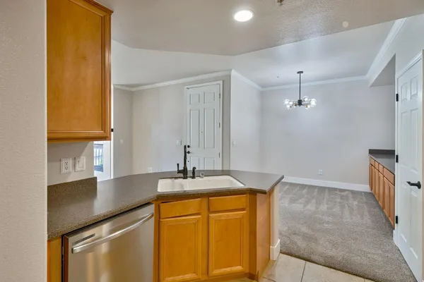 an empty room with ceiling fan and windows