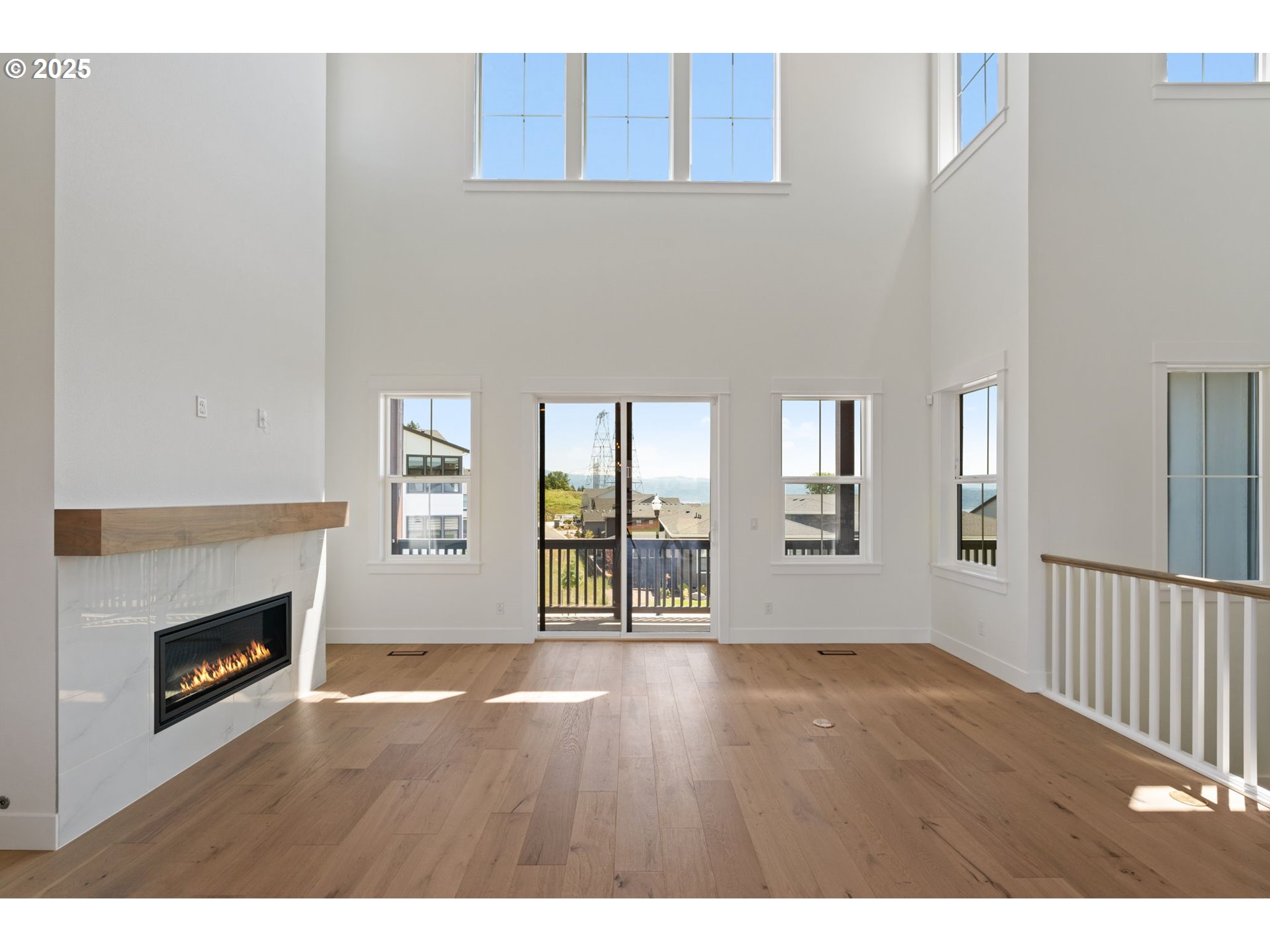 382 West Fir Loop Washougal, WA 98671 - Photo 11 of 47 a view of an empty room with wooden floor and a fireplace