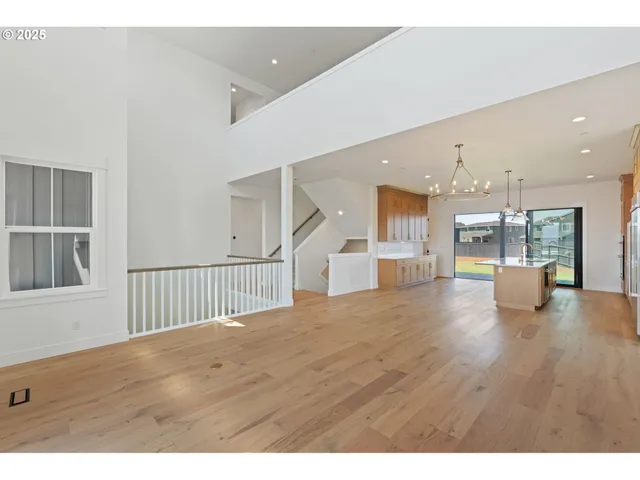 a view of kitchen and hall with wooden floor