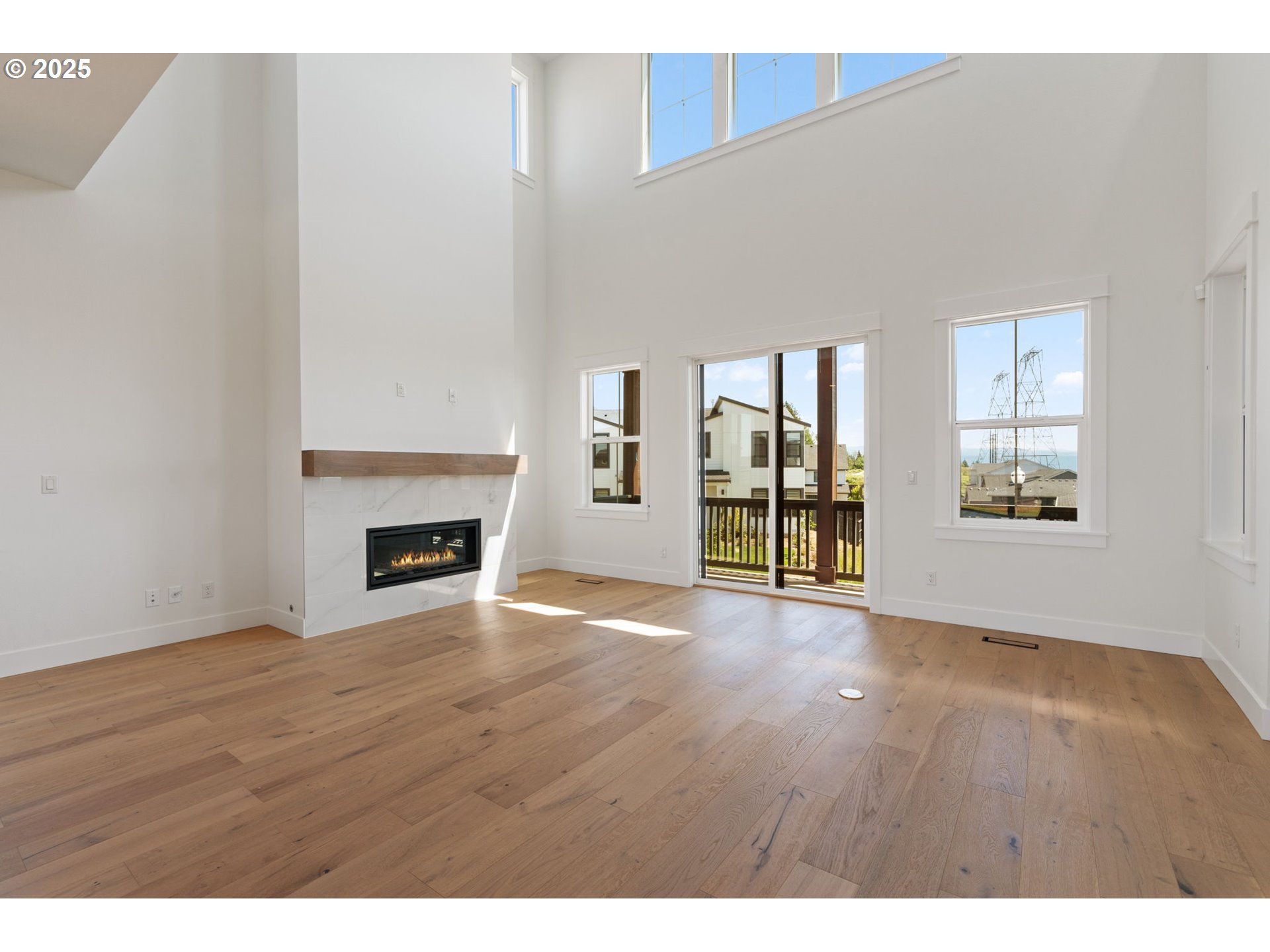 382 West Fir Loop Washougal, WA 98671 - Photo 10 of 47 a view of an empty room with wooden floor and a window