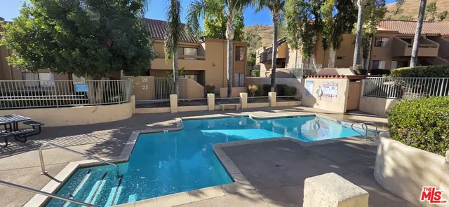 a view of a patio with couches and potted plants