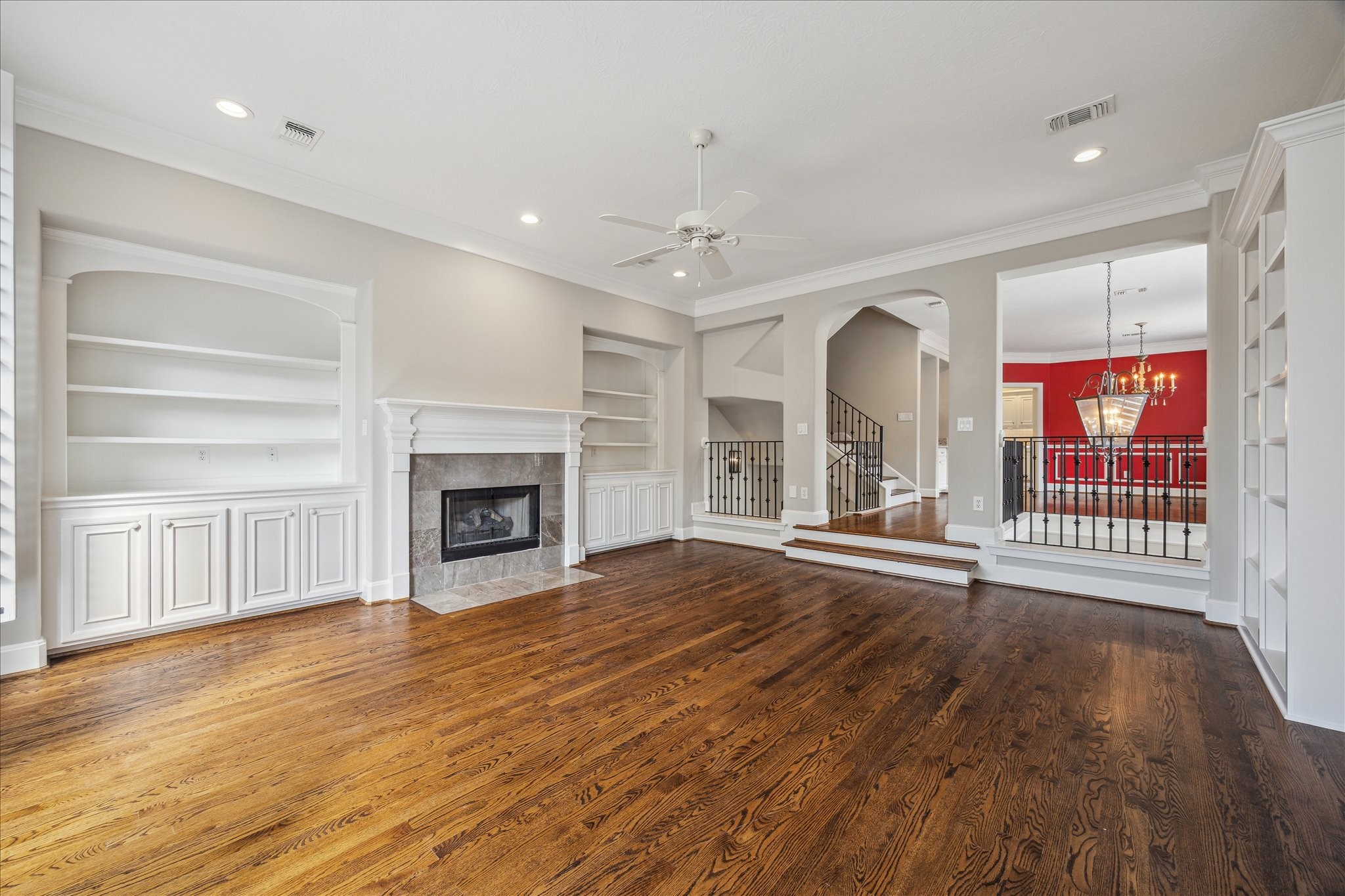 2817 Newman Street Houston, TX 77098 - Photo 11 of 36 a view of an empty room with wooden floor fireplace and a window