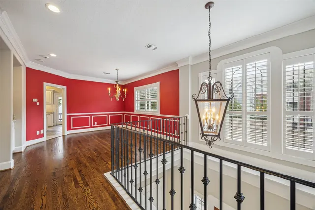 a view of an entryway with a floor to ceiling window and wooden floor