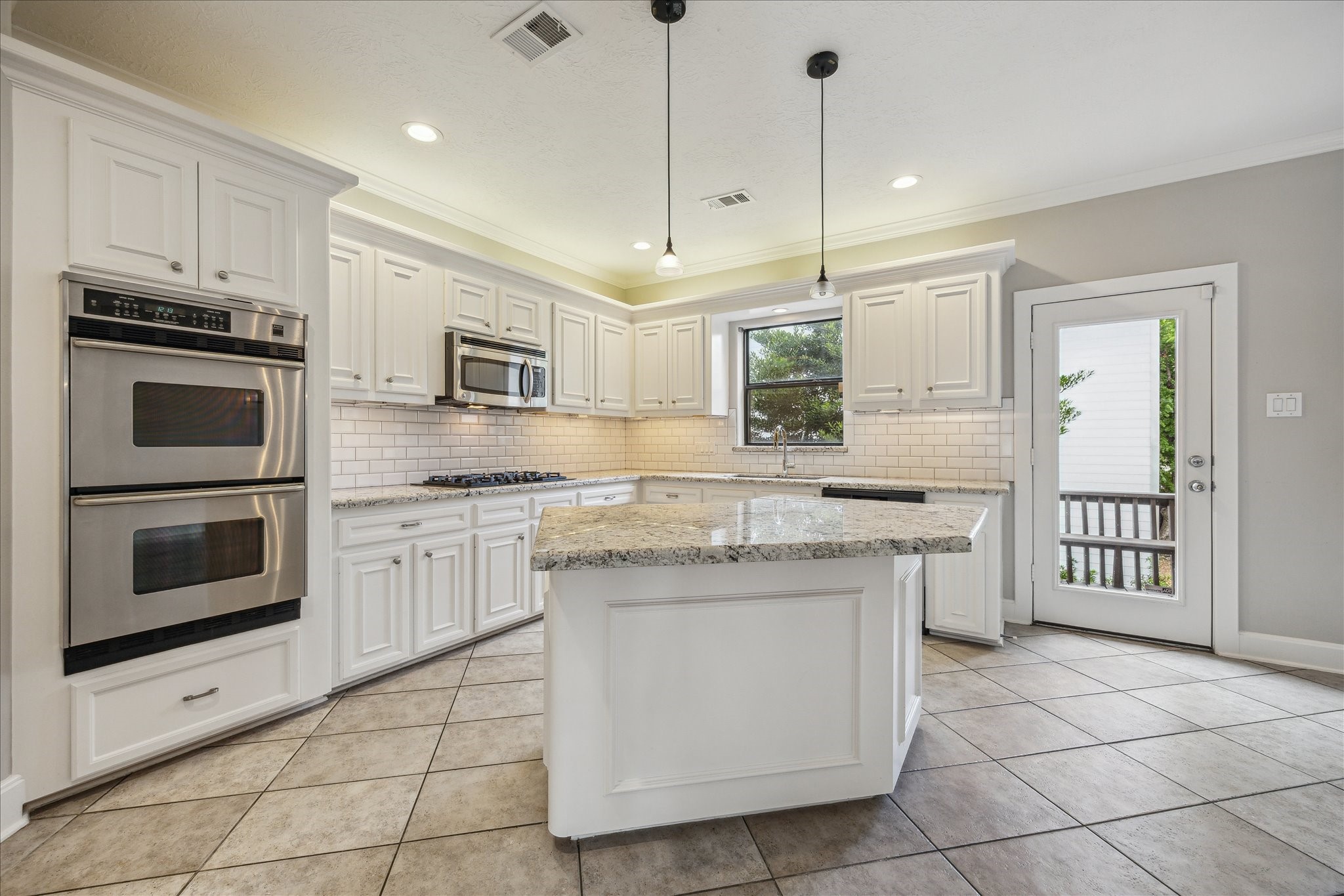 2817 Newman Street Houston, TX 77098 - Photo 15 of 36 a kitchen with granite countertop a stove sink and refrigerator